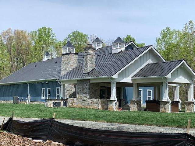 black standing seam metal roof on custom architectural home