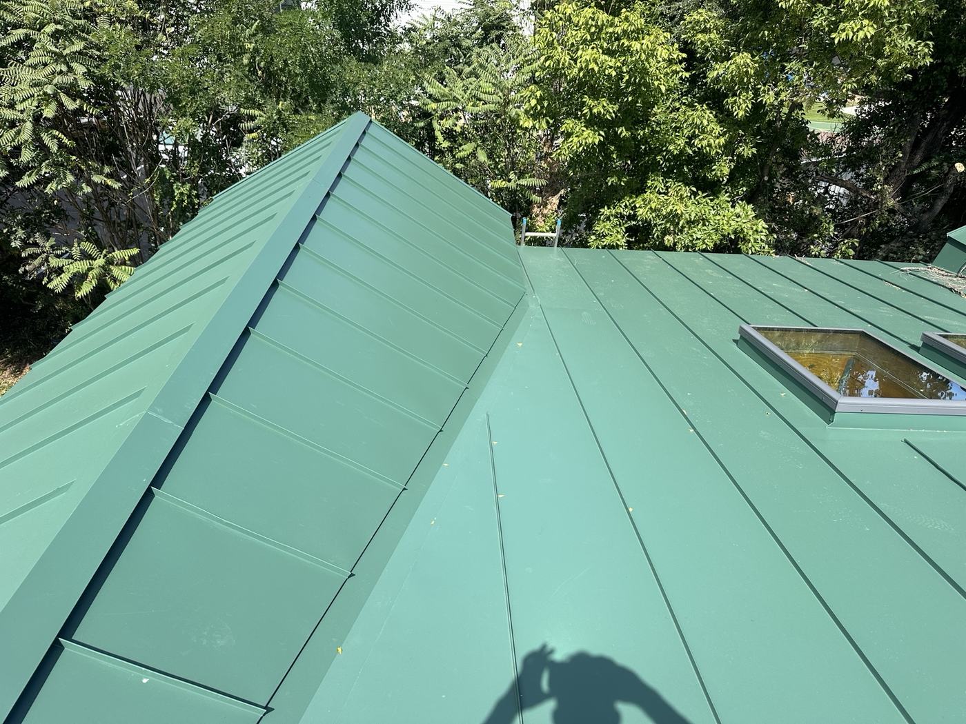 custom green standing seam metal roof panel valley detail